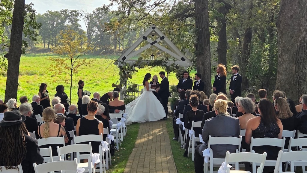 The best wedding venues in Iowa offer intimate settings, boutique hotel lodging, and a romantic Midwest getaway experience. Happy couple getting married in Okoboji