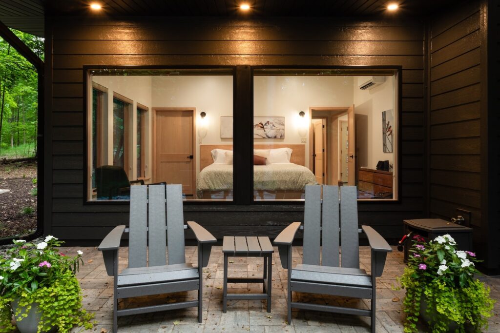 Two chairs on a patio in front of a bedroom at one of the most romantic cabin getaways in Wisconsin.