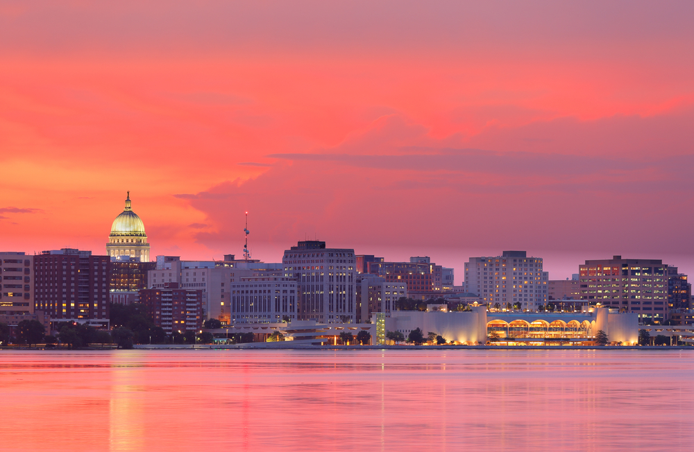 Plan a Midwest winter escape with the best things to do in Madison, including festivals, outdoor fun, and places to go in Wisconsin. City skyline at sunset