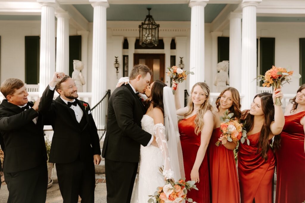 A happy couple celebrating with their wedding party at the best wedding venue in Nashville