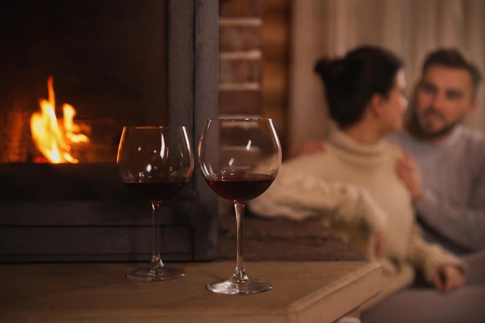 A couple enjoying wine by the fire during their romantic Valentine's Day getaway on the Eastern Shore of Maryland