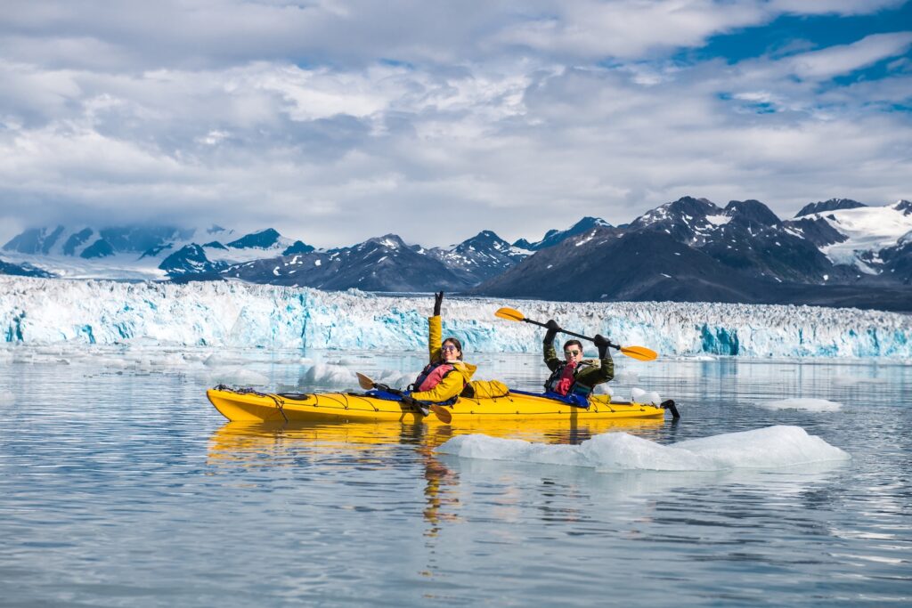 Happy couple enjoys ocean kayaking. Planning an Alaska trip? These best Juneau excursions highlight wildlife, glaciers, and unforgettable summer shore adventures.