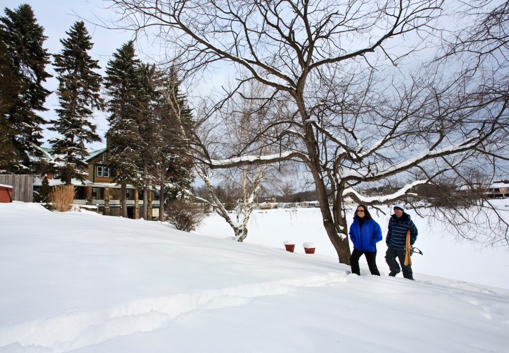 Couples looking for anniversary getaway ideas will love exploring Deep Creek Lake Maryland covered in snow. A couple here is exploring on snowshoes