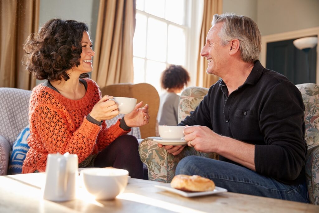 Middle Aged Couple Sitting Around Table In Coffee Shop after exploring all the best things to do in Sharon PA
