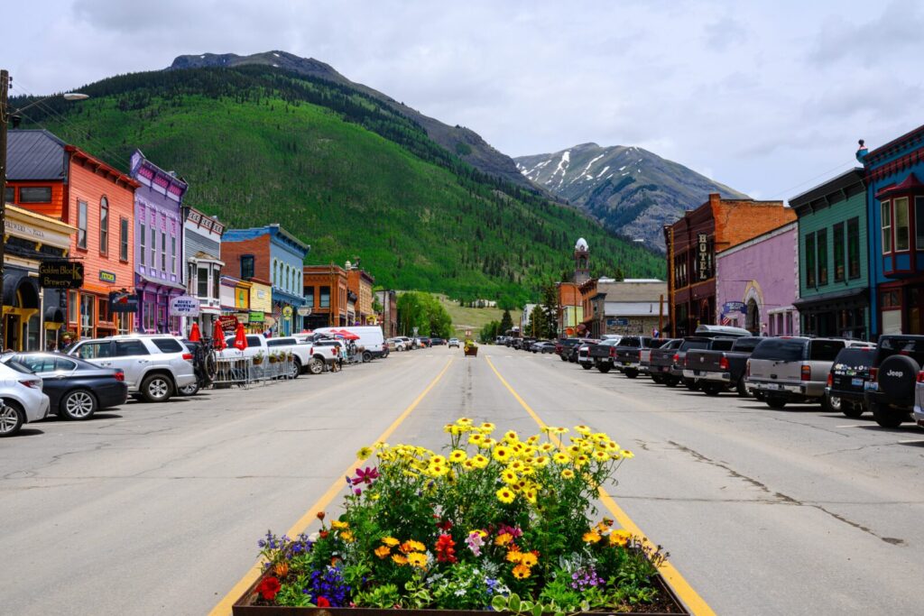 Explore one of the best Colorado mountain towns near Durango on your next visit, this is a pretty small town street with flowers and cars parked along the streets