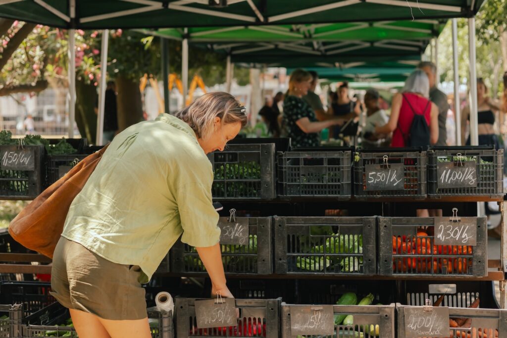 A middle aged woman exploring the Dane County Farmers Market in Madison WI This Spring