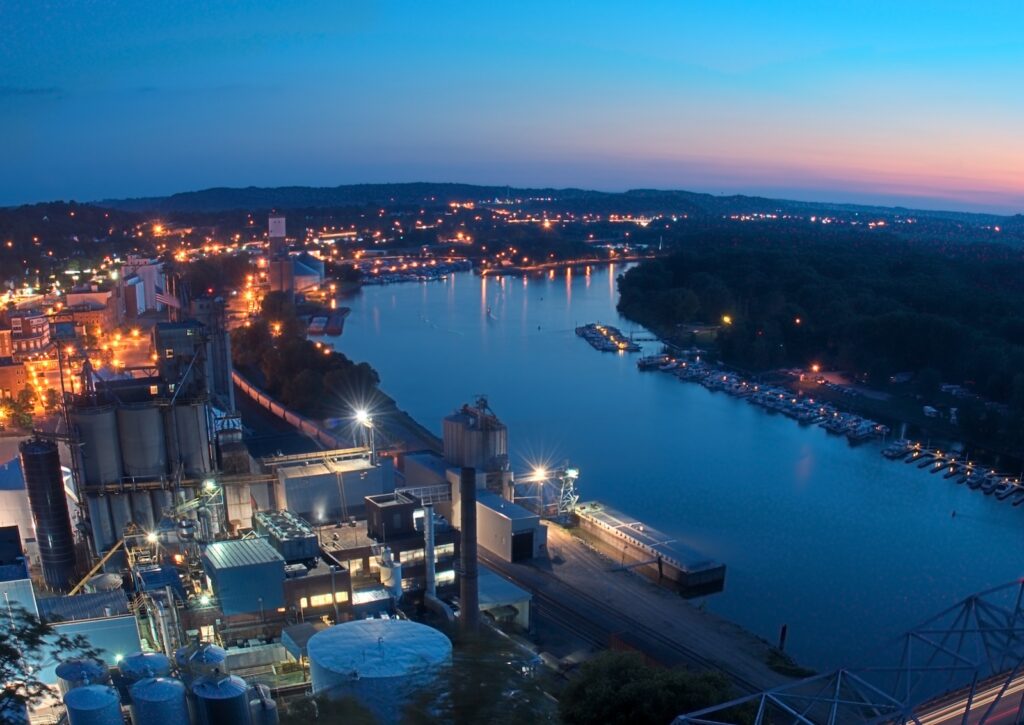 Downtown Red Wing MN with sunset - industrial site and bridge to Wisconsin in foreground