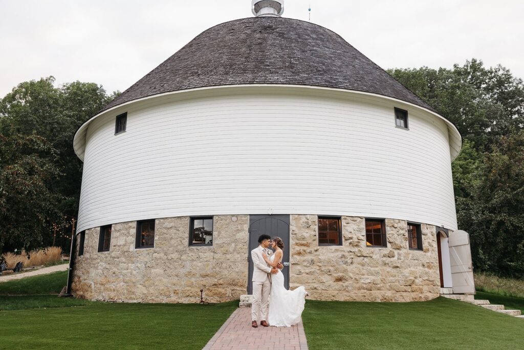 Couple in front of our historic round barn, one of the most unique places to get married in MN.