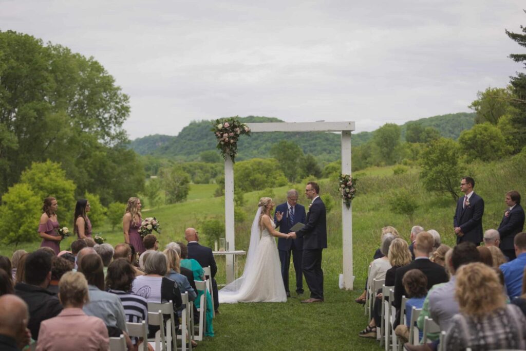 Happy couple getting married outside at Round Barn Farm, learn how to plan a wedding here