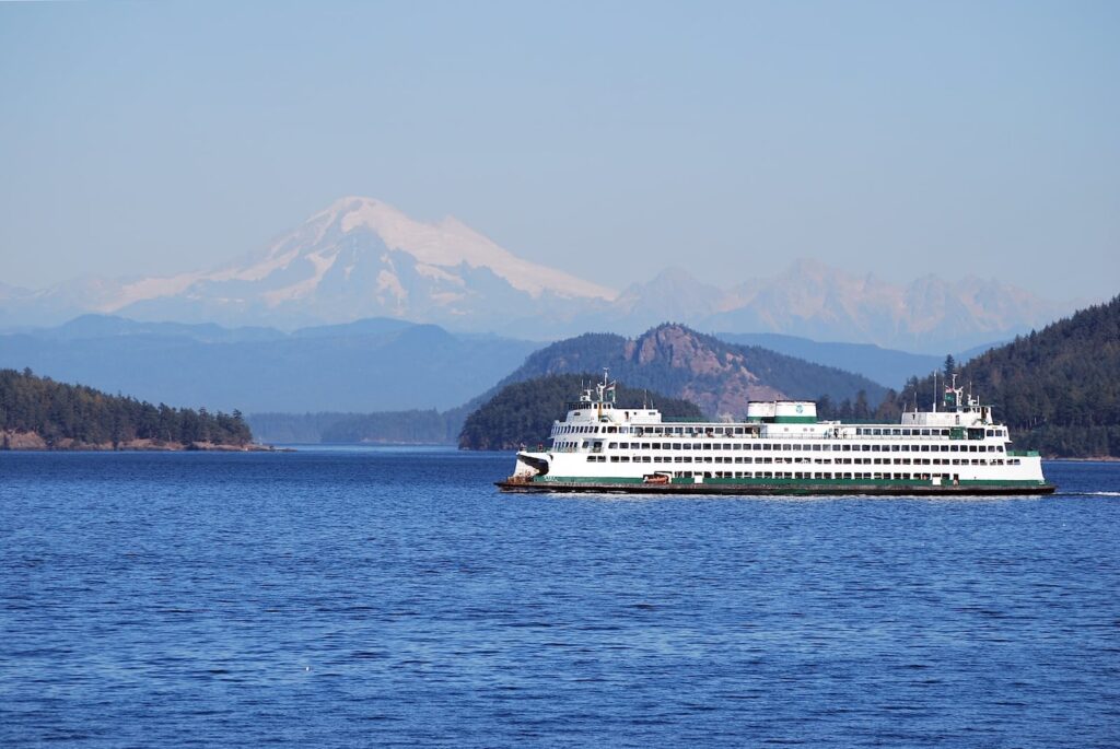 Ride the San Juan Island Ferry to Friday Harbor on this scenic journey through the islands with mountain backdrop