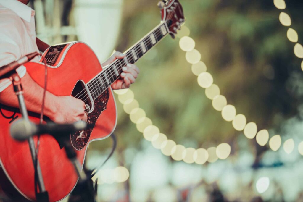 Man playing guitar at Oregon Coast Music Festival