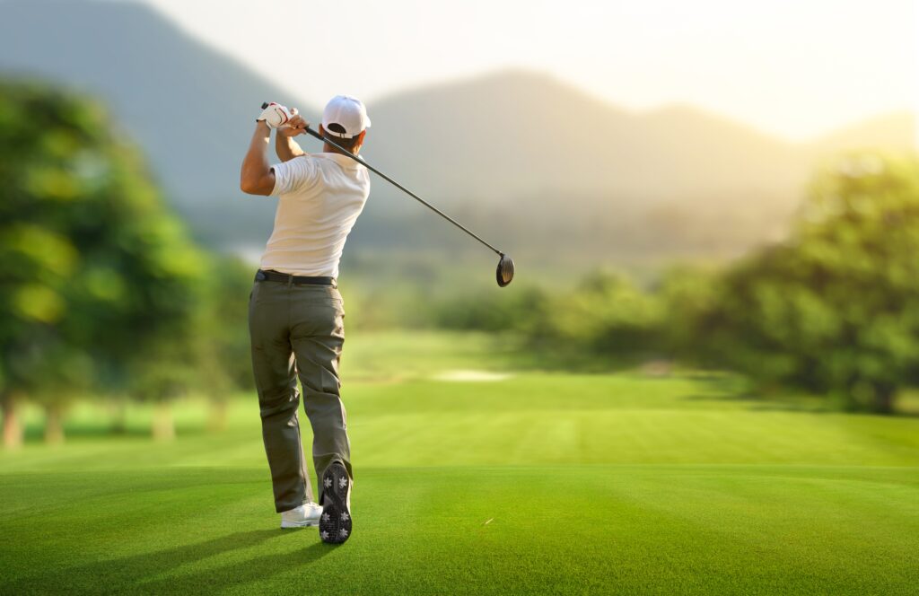 Golfer hit sweeping drive after hitting golf ball down the fairway. Wisp Resort Golf.