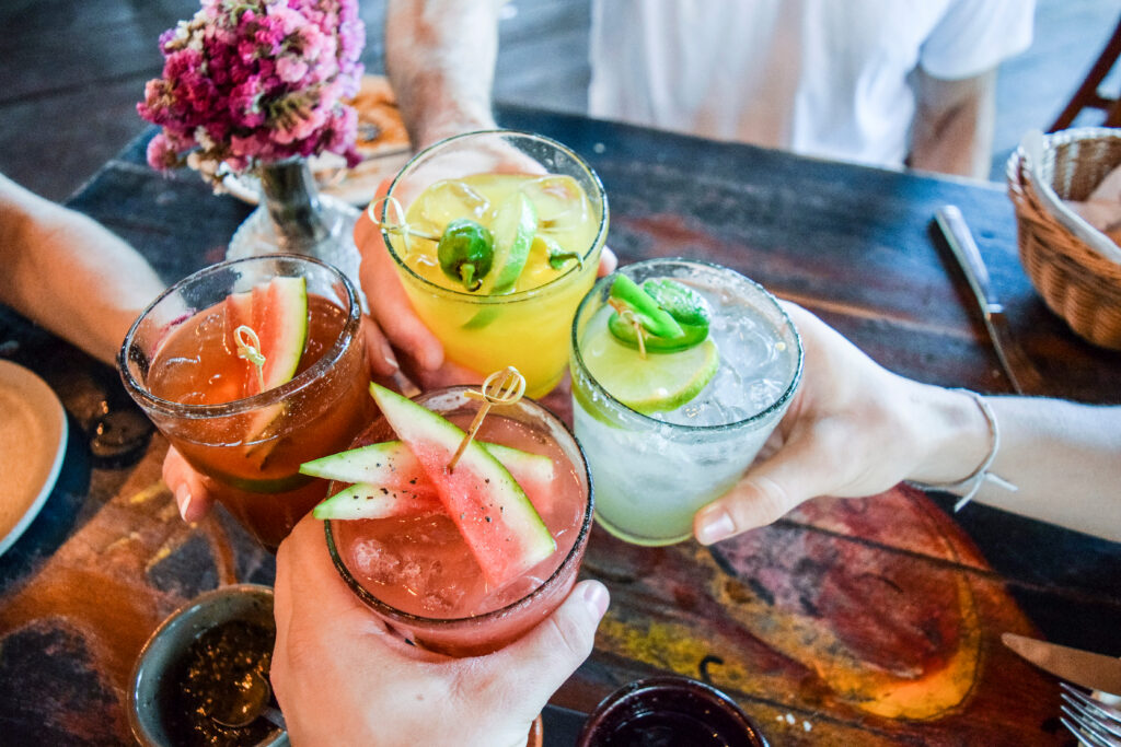 Friends toasting with cocktails at an Old Town restaurants in Albuquerque