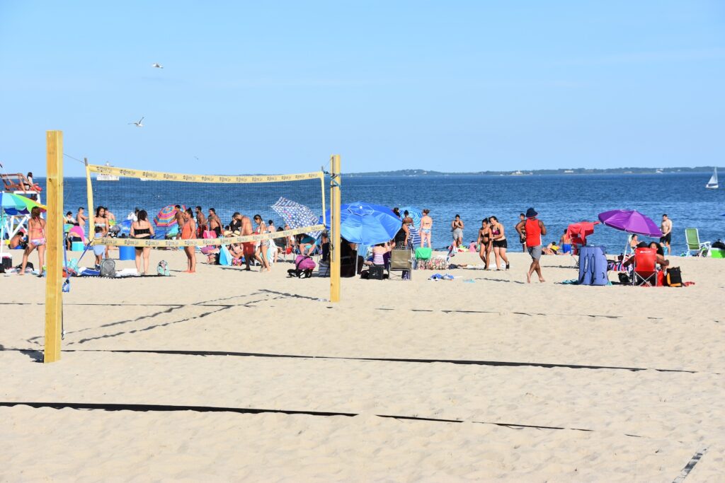 People playing volleyball at one of the best beaches near Mystic CT