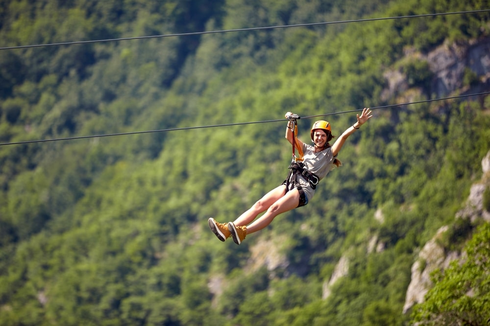 Woman riding the Gorge Zipline in the mountains of Saluda, NC