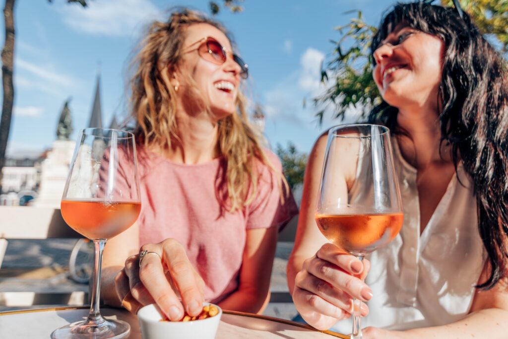 smiling ladies enjoy quality time having conversation and drinking wine at Madrone Cellar in Friday Harbor