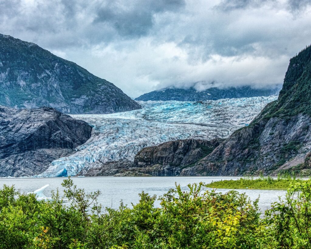 The Mendenhall Glacier tours in Juneau, Alaska surrounded by majestic mountains