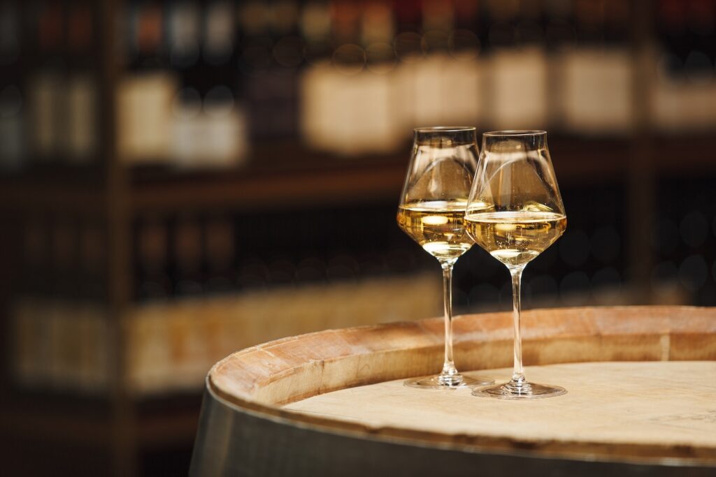 Two Glasses of White Wine Resting on Wooden Barrel at City Winery Nashville