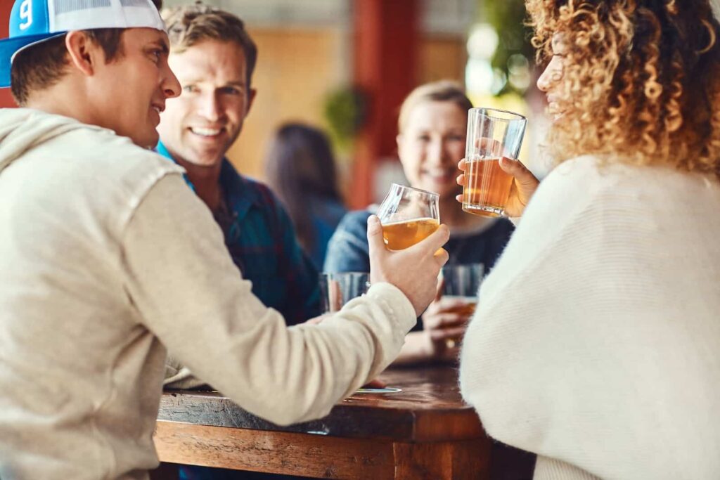 A group of friends enjoying glasses of beer on the Charlottesville Ale Trail in Virginia.