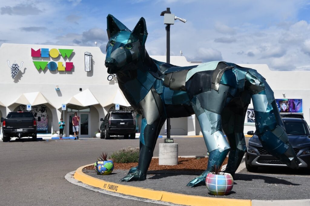 A large wolf statue in from of Meow Wolf's House of Eternal Return, one of the best museums in Santa Fe.