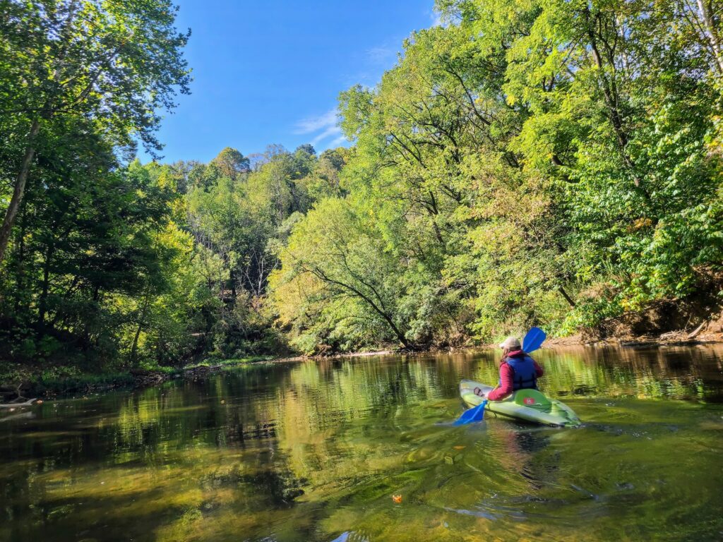 Kayaking in hocking hills, a solo kayaker enjoying the calm river