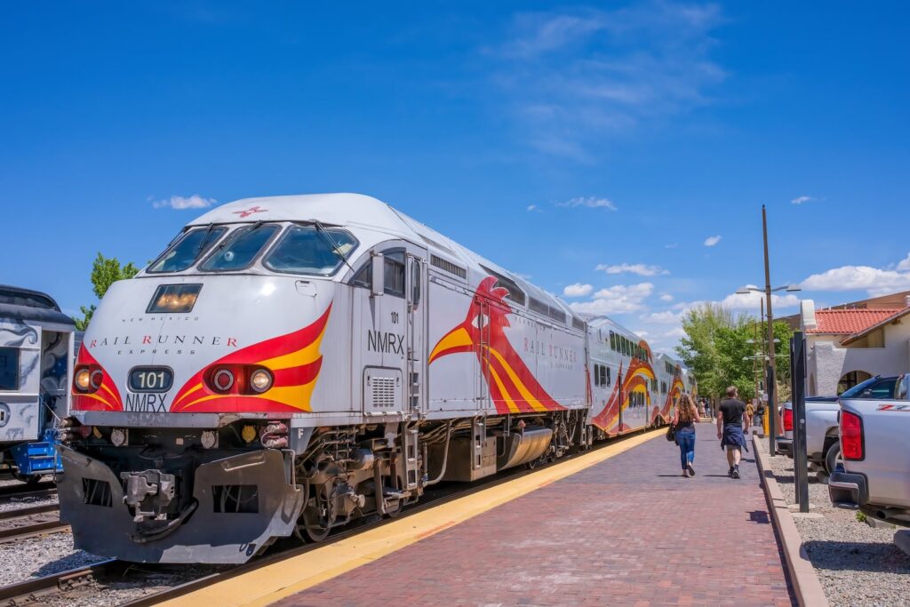 The New Mexico Railrunner Express waits for passengers in the Santa Fe Railyard, the best place to catch a Santa Fe train.