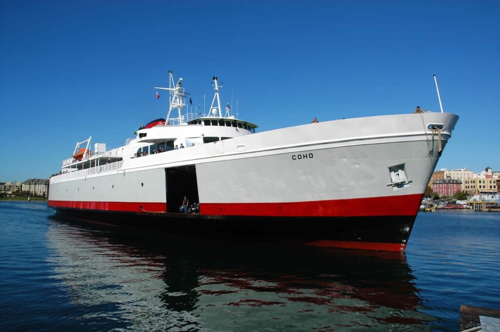 A red and white Victoria to Port Angeles ferry, the Coho, on the water.