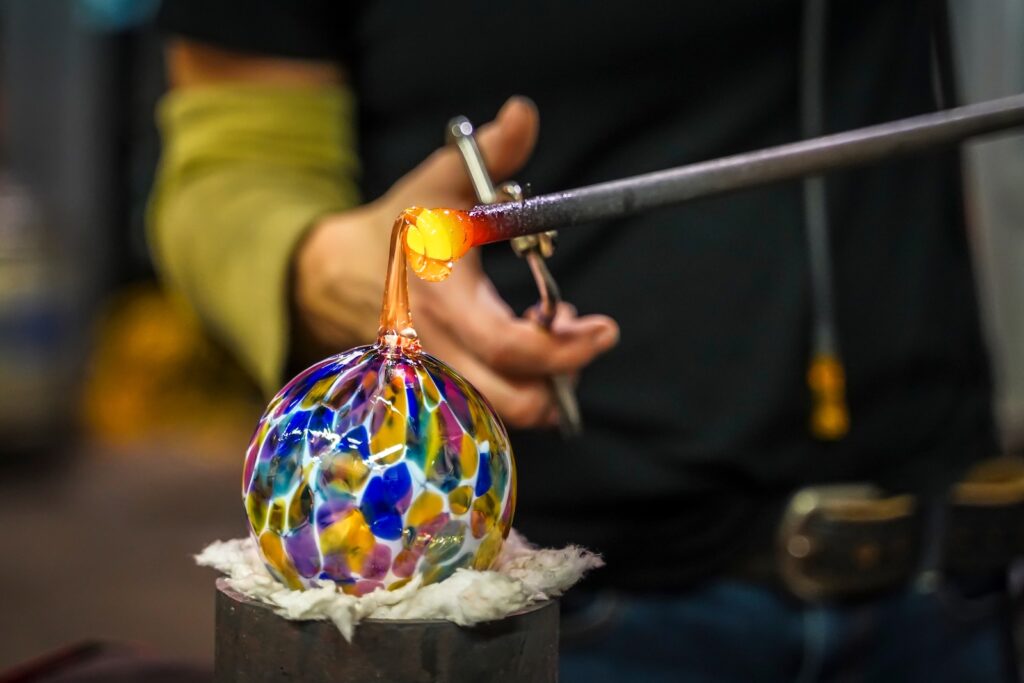 A Glass Blower Shaping Molten Glass into a Piece of Art, glassblowing in Hocking Hills is such a great outing