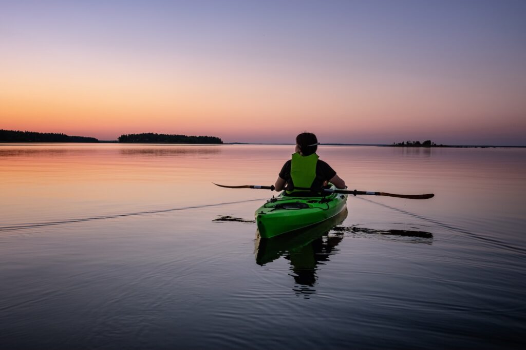 woman Kayaking on San Juan Islands at sunset