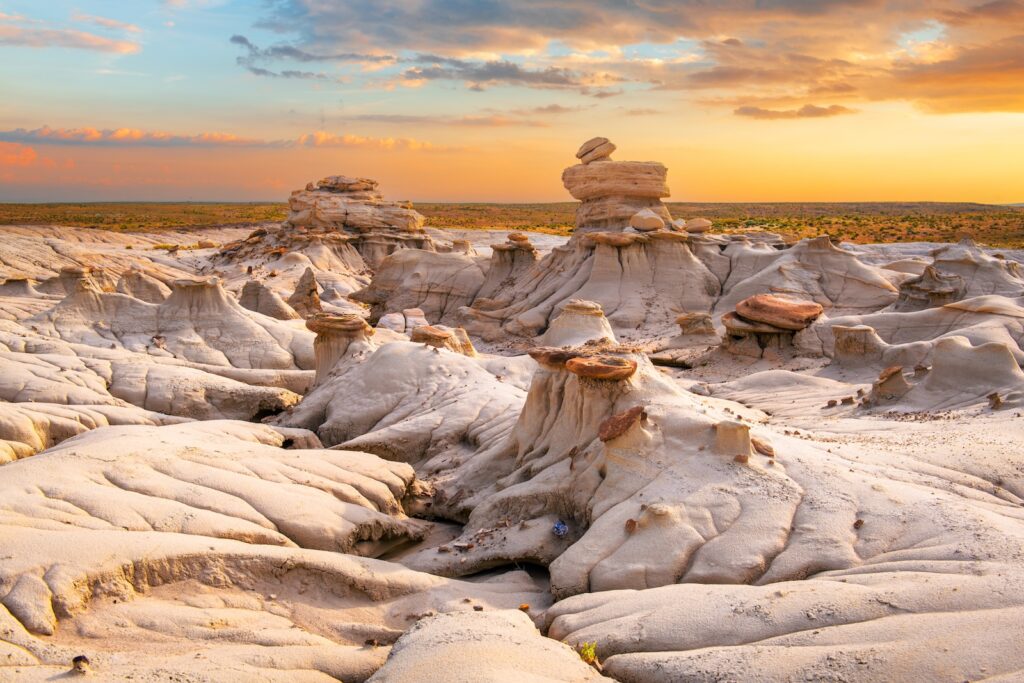 The Bisti Badlands, featuring rock formations at the Valley while the sun is setting.