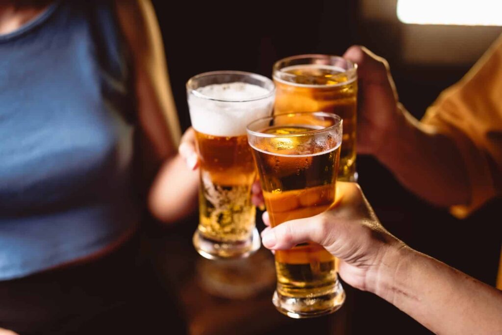 Three friends toasting beer at Dog Rose Brewing in St. Augustine, FL.