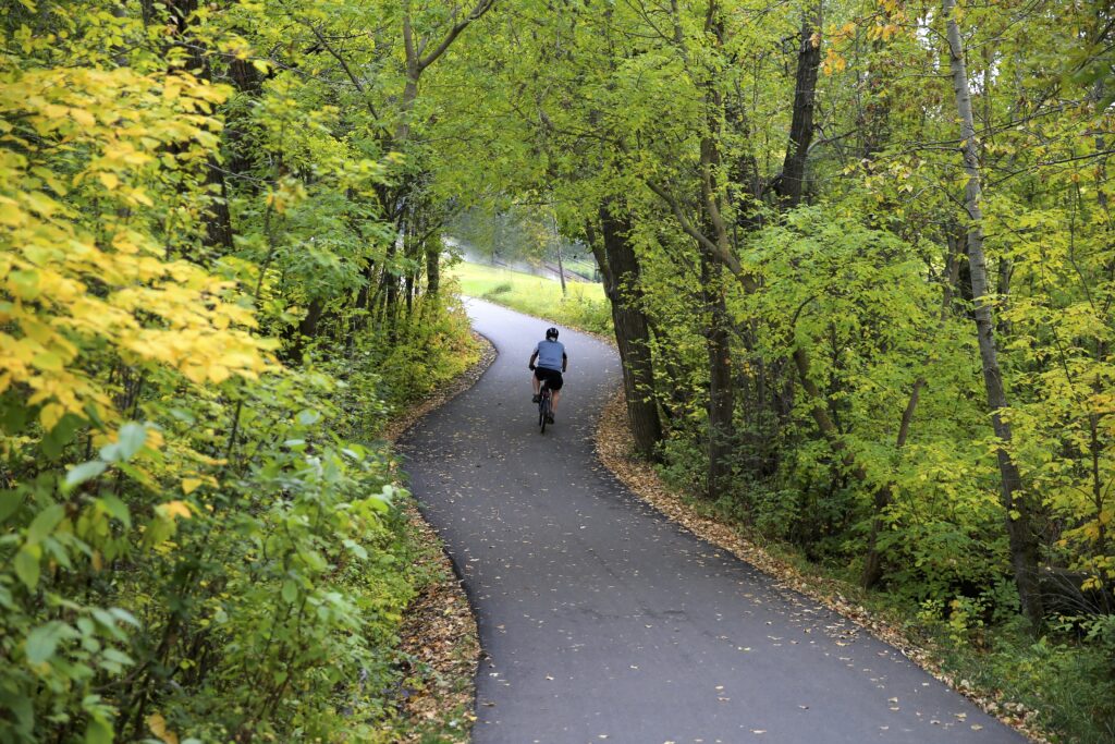 Cyclist on paved Minnesota bike trail in Stillwater.