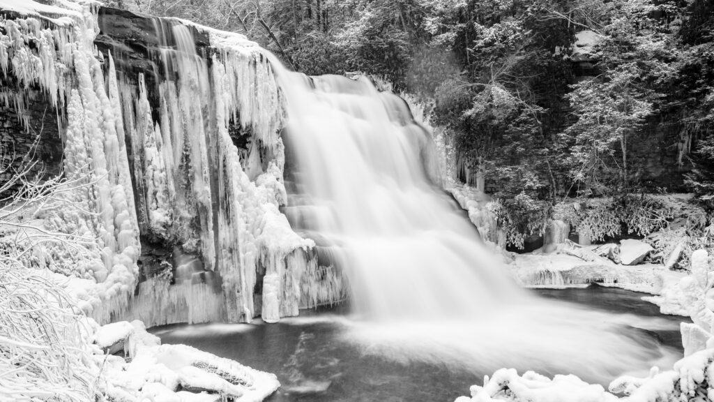 Muddy Creek Falls frozen in winter. Snowshoeing to the falls is one of the best Deep Creek Lake winter activities.